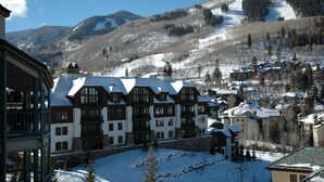 A snow-covered mountain town with traditional chalet-style buildings, a ski slope in the background, and a clear blue sky. - Centennial Studio Condo Unit 11a (Avon)