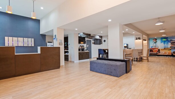 A spacious lobby with a reception desk, a seating area, and a kitchen visible in the background. - Best Western Plus New Barstow Inn & Suites (Barstow)