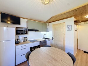 A compact kitchen with a microwave, toaster, and sink.