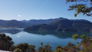 A serene lake surrounded by mountains. - Luxury Self Contained Unit,Wide Views (Portage)