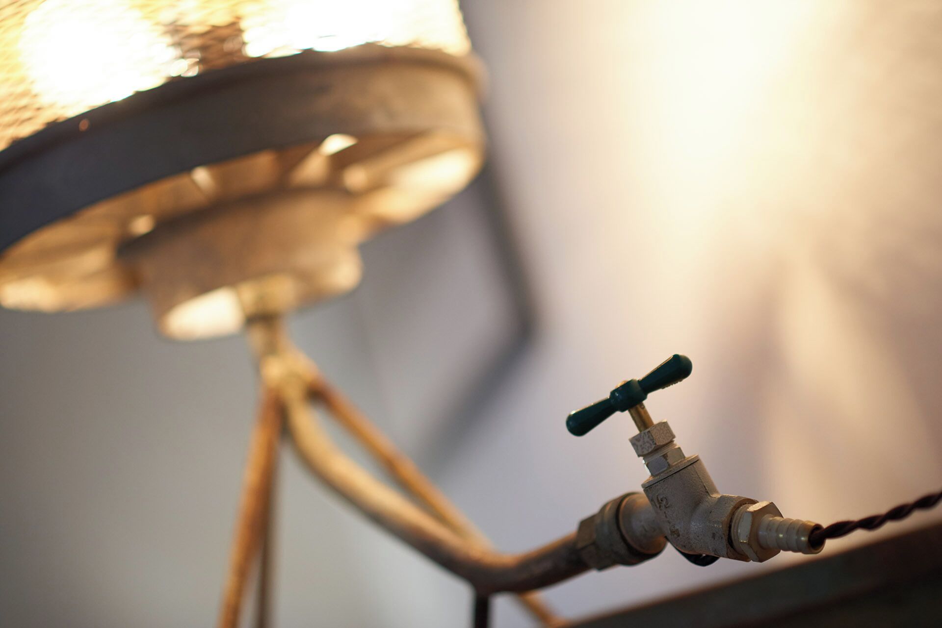 A close-up of a vintage-style lamp with a metallic base and a switch.
