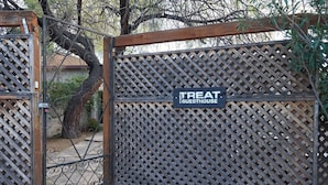 A gated entrance to a property labeled "Treat Guesthouse".