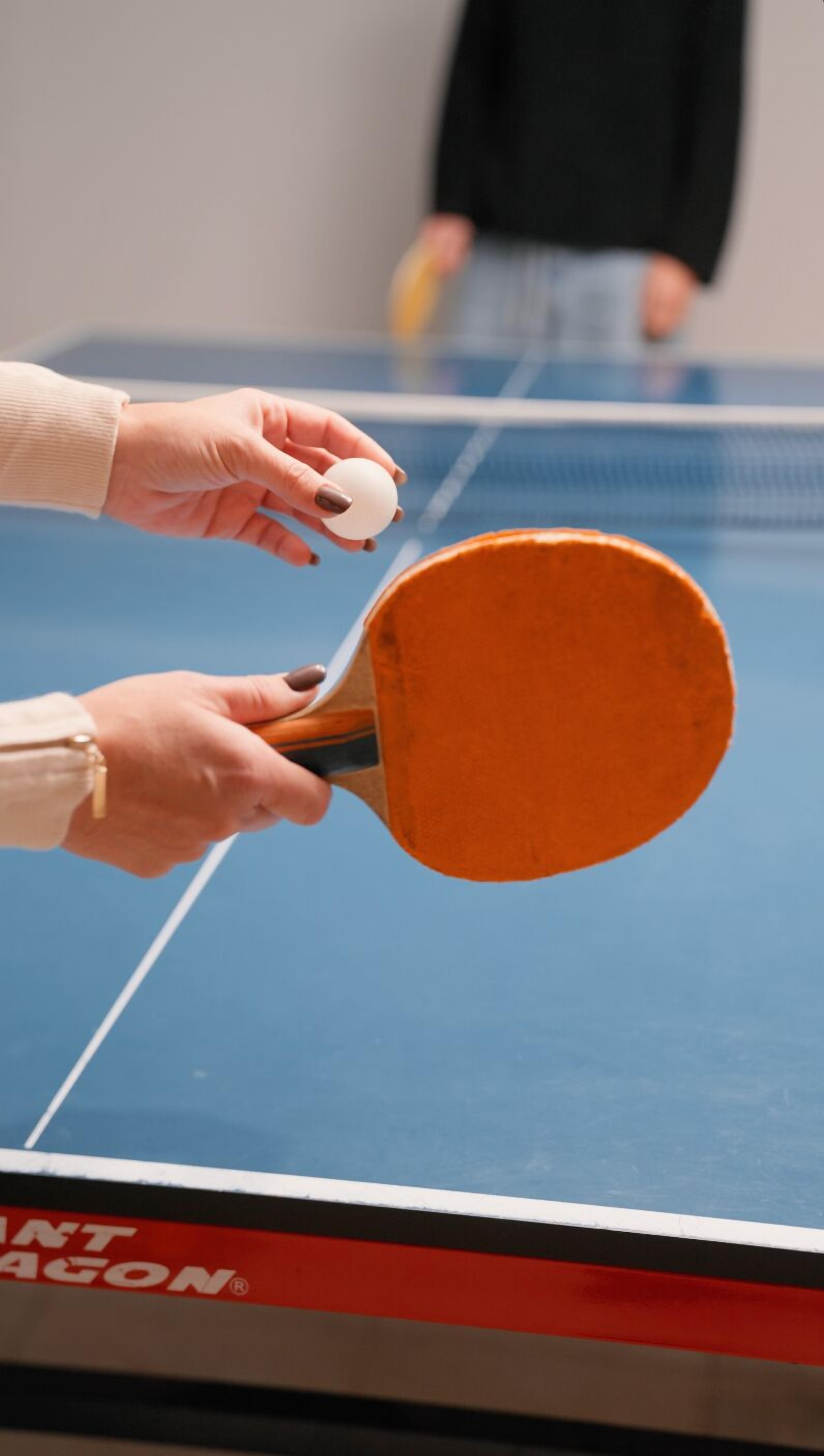 A table tennis table with a red and black border and a visible brand name.