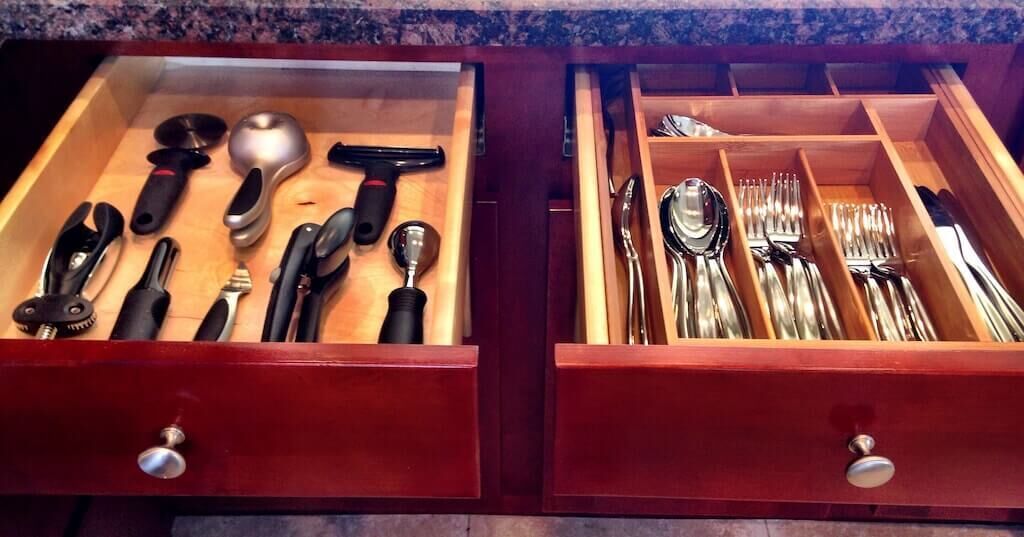 A drawer with kitchen utensils and cutlery.