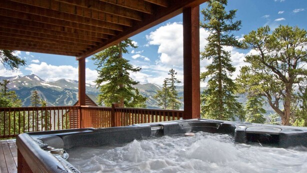 A hot tub with a wooden deck and a mountain view. - Spectacular Views, Hiking & Skiing, Spacious Cozy Luxury, Hot tub, Fireplace (Breckenridge)