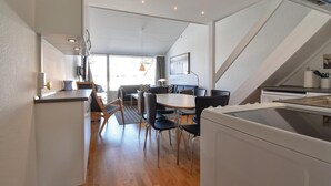 A modern kitchen with a dining area, wooden flooring, and a view of the outdoors. - Awesome apartment in Faaborg with WiFi (Faaborg)