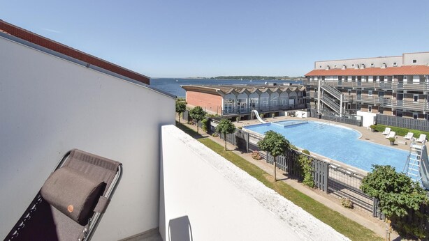 A hotel with a pool, outdoor seating, and a view of the sea. - Awesome apartment in Faaborg with WiFi (Faaborg)