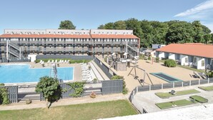A multi-story hotel with a swimming pool, outdoor seating, and a small tennis court. - Awesome apartment in Faaborg with WiFi (Faaborg)