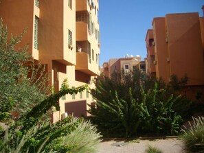 Stylish residential area surrounded by lush greenery and palm trees.