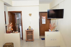 Welcome to our reception area, featuring a central desk, flat-screen TV, and comfortable seating.