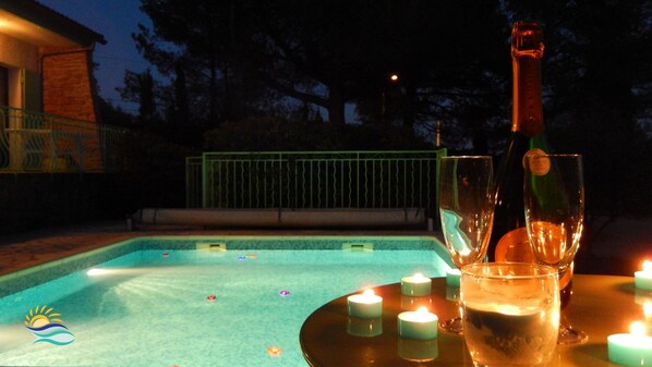 A poolside setting with a table, candles, and a bottle. - Charming villa with private pool and summer kitchen ♥ Near Calanques (Ceyreste)
