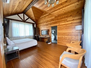 A wooden cabin with a bed, desk, TV, and two chairs. - Puli Diary (Puli)