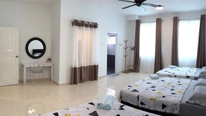 A hotel room with two beds, a desk, a chair, a mirror, and a ceiling fan. - Sandakan Hill Terrace 3 (Sandakan)