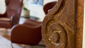 A close-up of a wooden column with a carved spiral design, part of a room's interior.