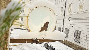 A snow-covered street with a building in the background.