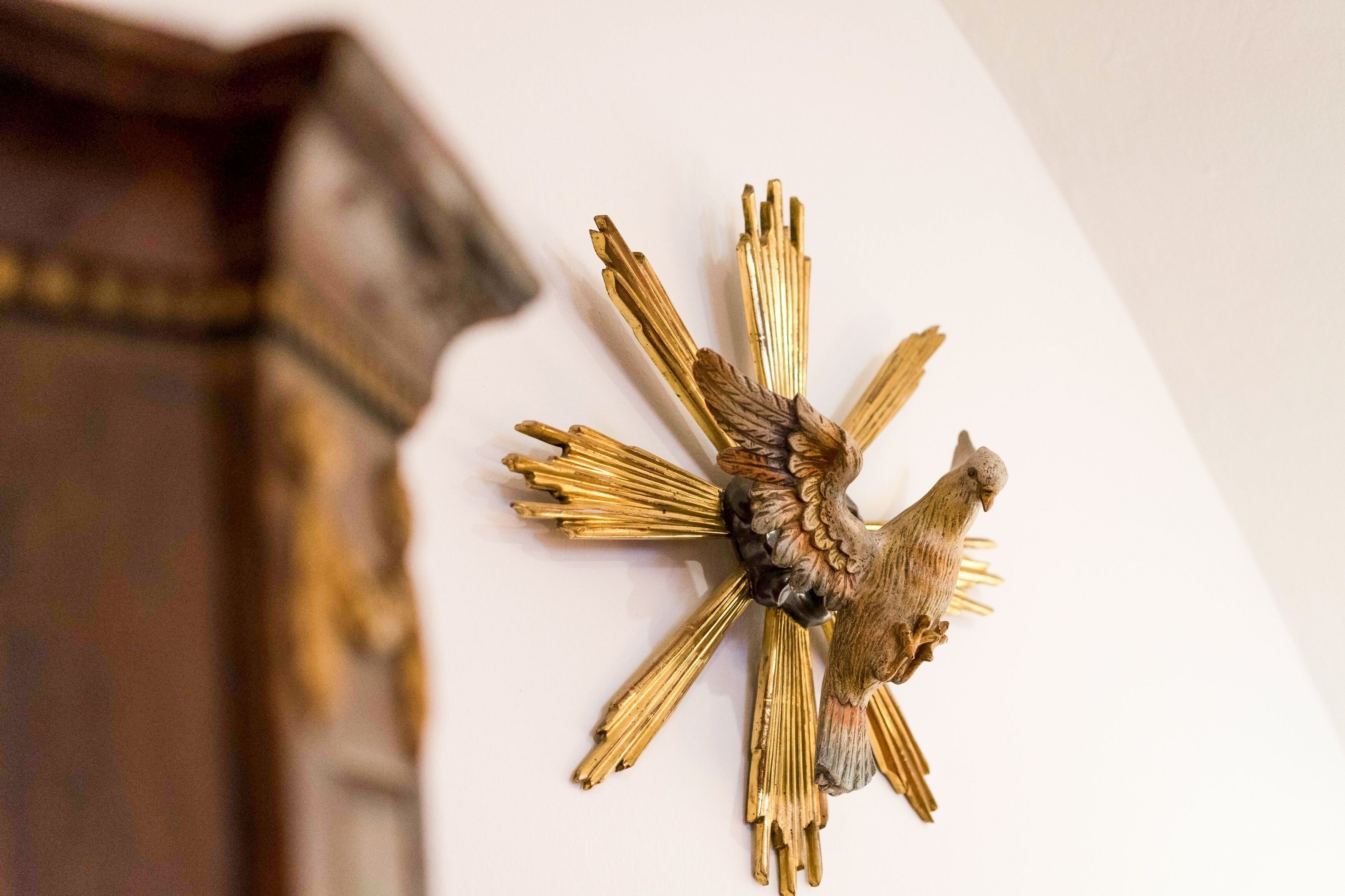 A wall-mounted decorative piece with a bird and radiating elements.