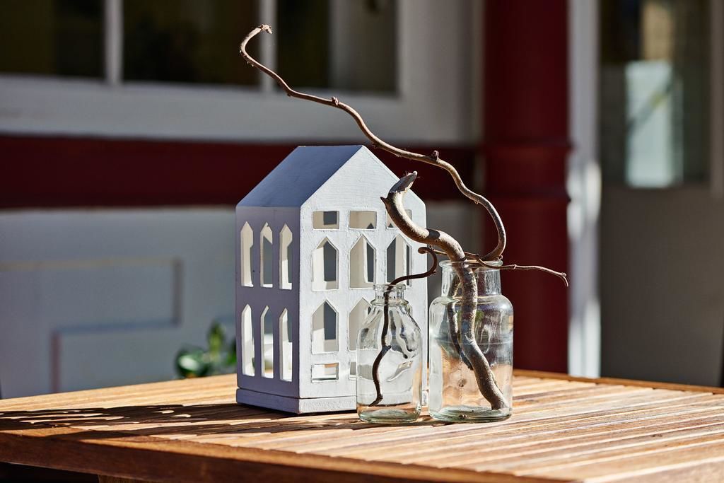 A model house with a blue roof and white walls on a wooden table.