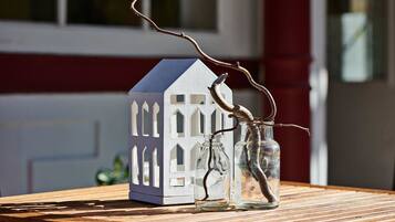 A model house with a blue roof and white walls on a wooden table.