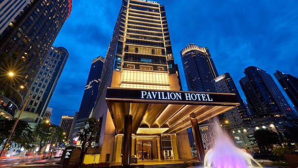 The Pavilion Hotel with a prominent entrance, a fountain, and surrounding high-rise buildings. - Pavilion Hotel Kuala Lumpur Managed by Banyan Tree (Kuala Lumpur)