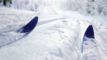 A snowy path with two blue skis.