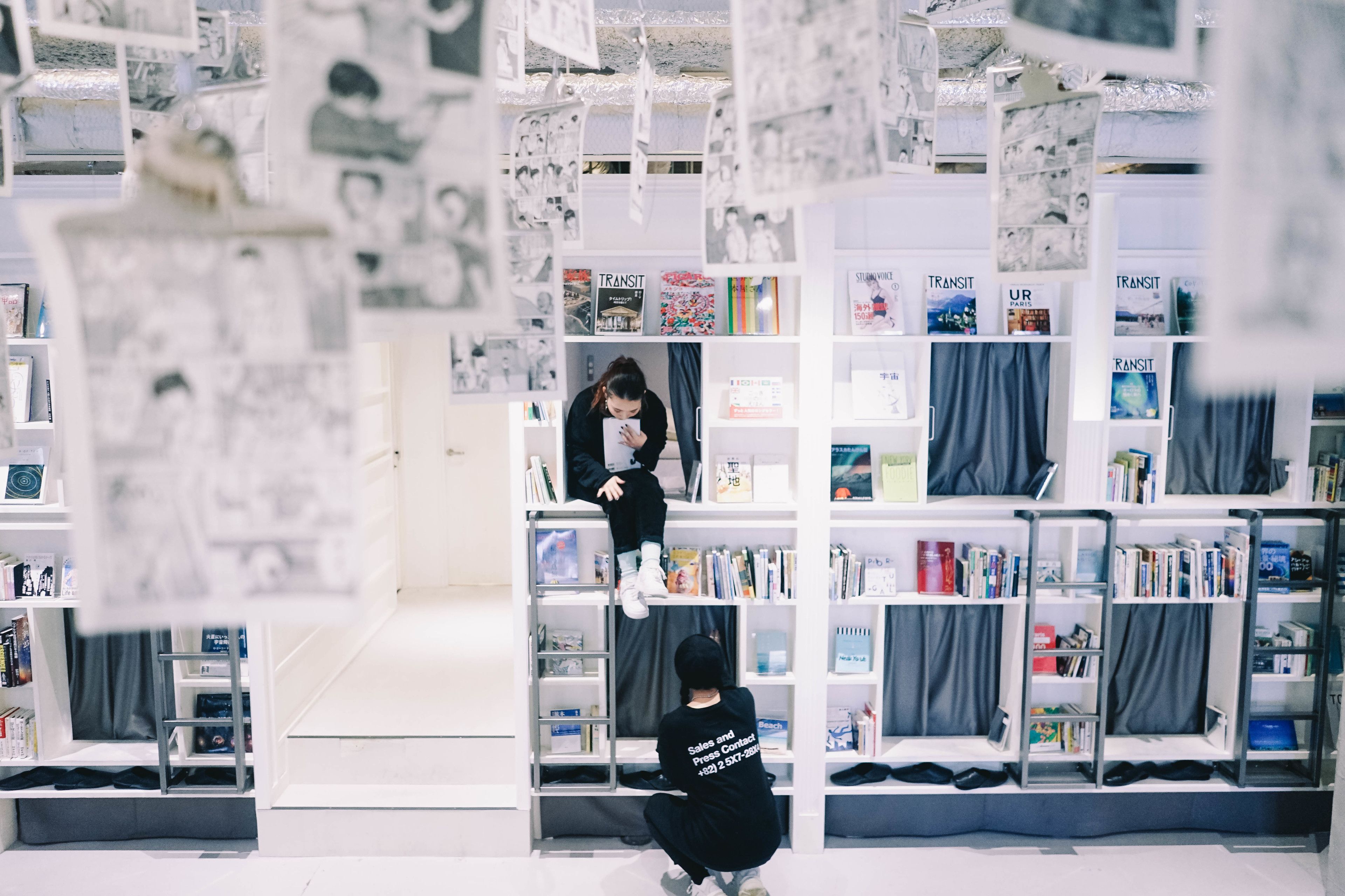 A bookstore with multiple shelves filled with books and magazines.