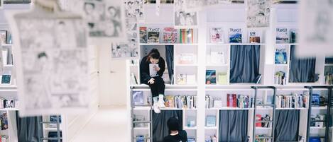 A bookstore with multiple shelves filled with books and magazines.