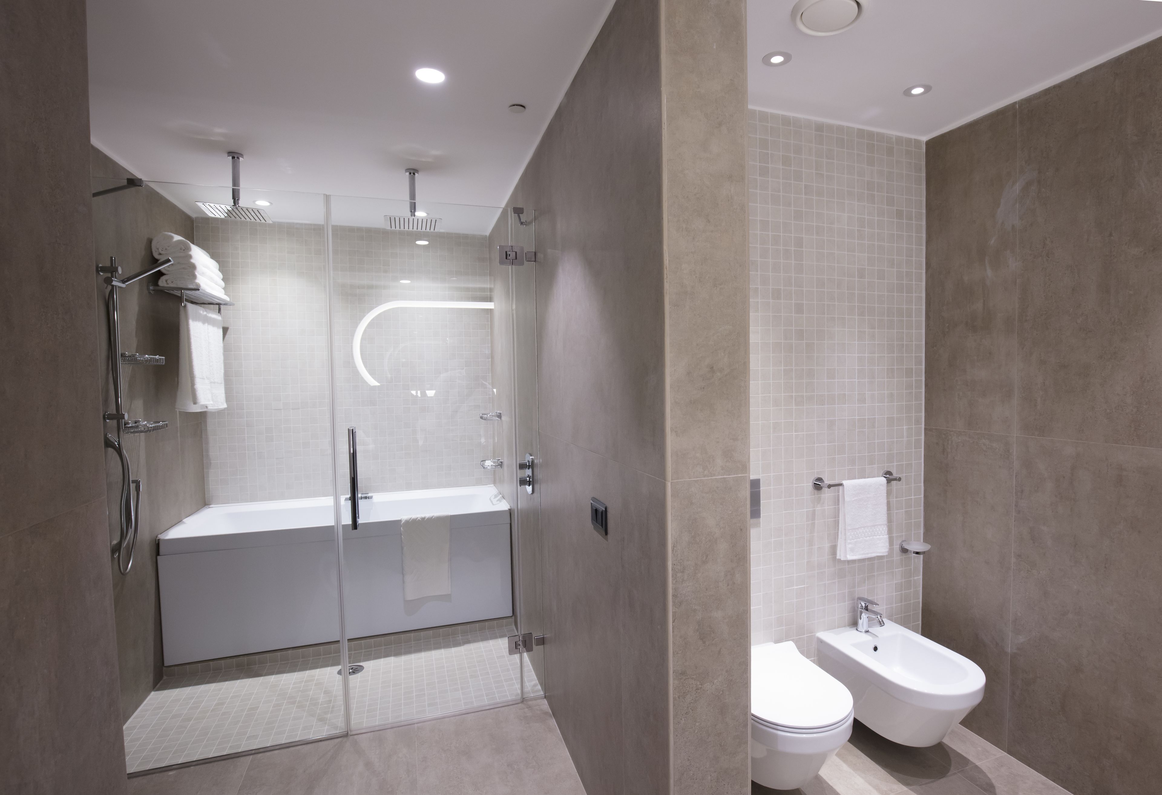 deluxe suite, 1 king bed | bathroom | combined shower/bathtub, free toiletries, hair dryer, slippers