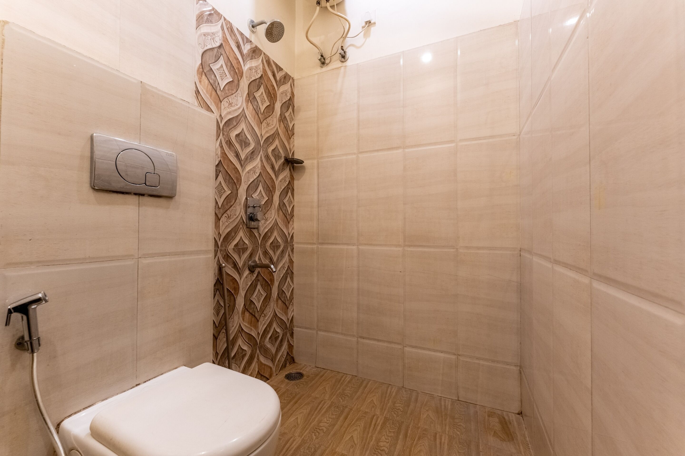 Un baño con ducha, inodoro y panel de control.
