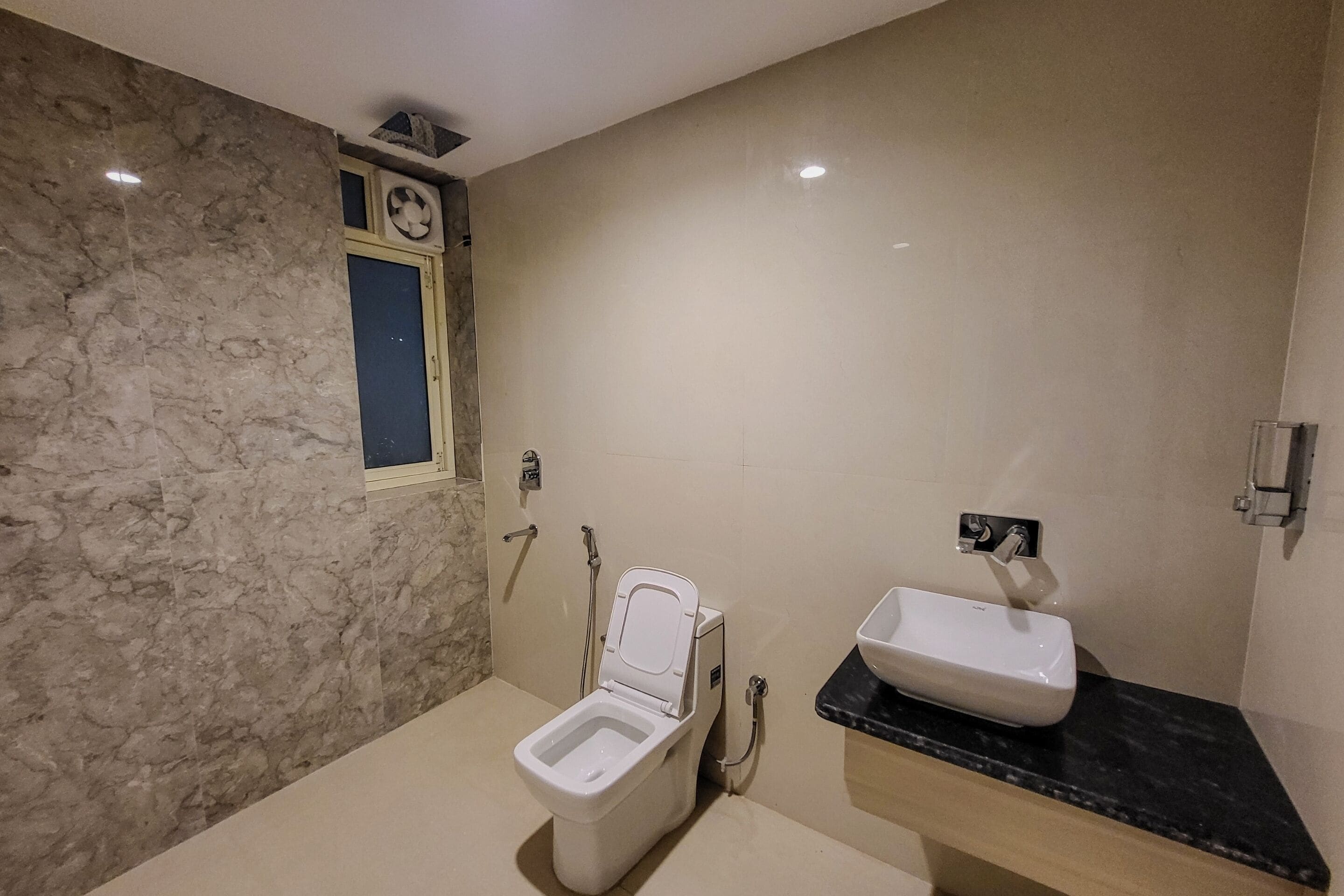 A bathroom with a toilet, a sink, and a shower.