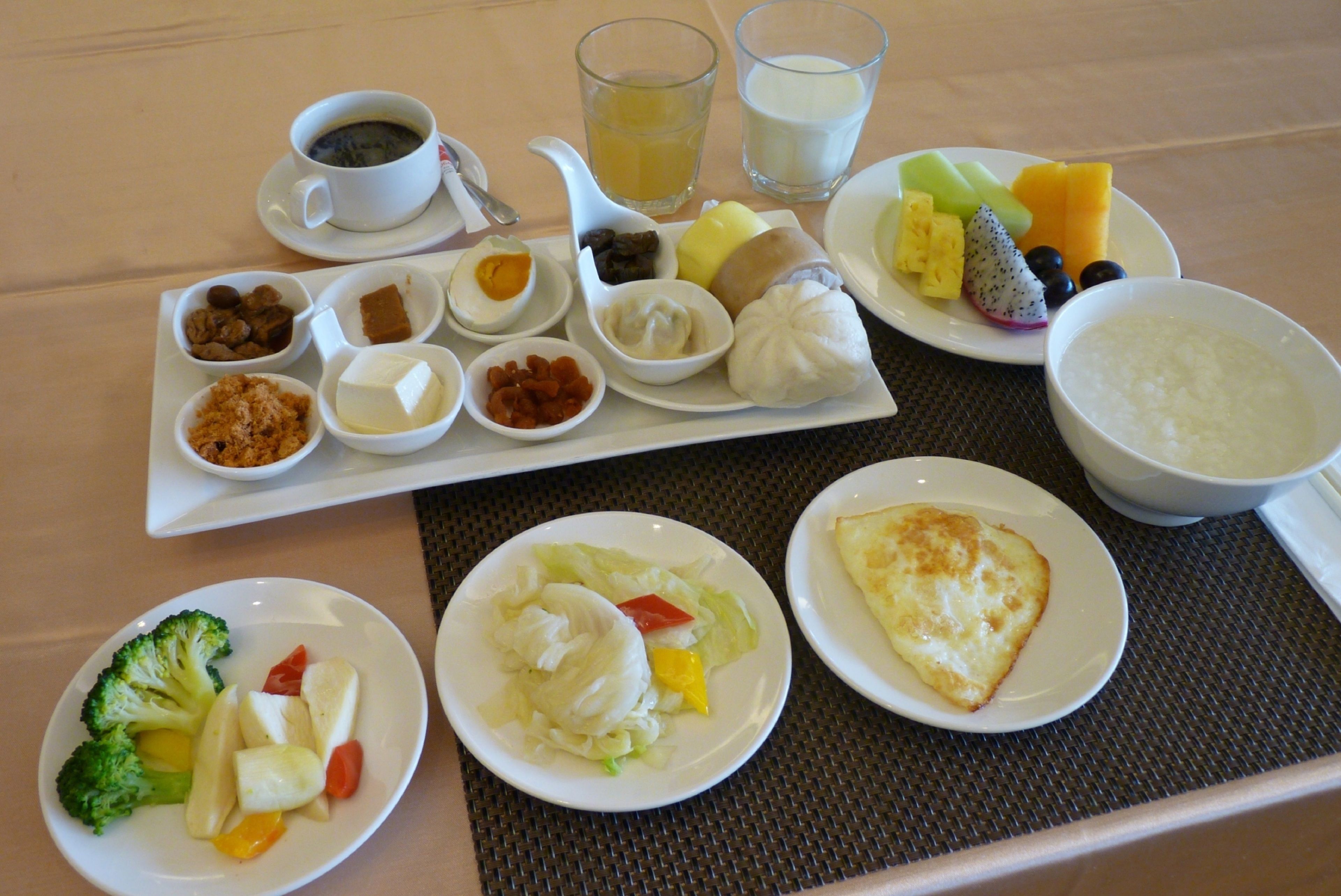 A breakfast buffet with various dishes and beverages.