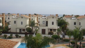 A row of modern, two-story buildings with flat roofs, likely part of a residential complex. - Jolie Villa (Sotira)