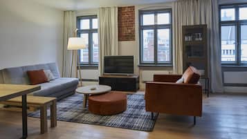 Premium Apartment, Non Smoking, City View | Living room | Smart TV, foosball, table tennis, books