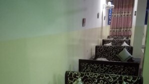 A staircase with patterned sofas and a vase with a flower. - Hotel Riddhi Siddhi Restaurant & Bar (Birgunj)