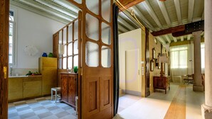 A spacious kitchen with a checkered floor, wooden cabinets, and a large window. - Ca' del Ramo D'oro (Venice)