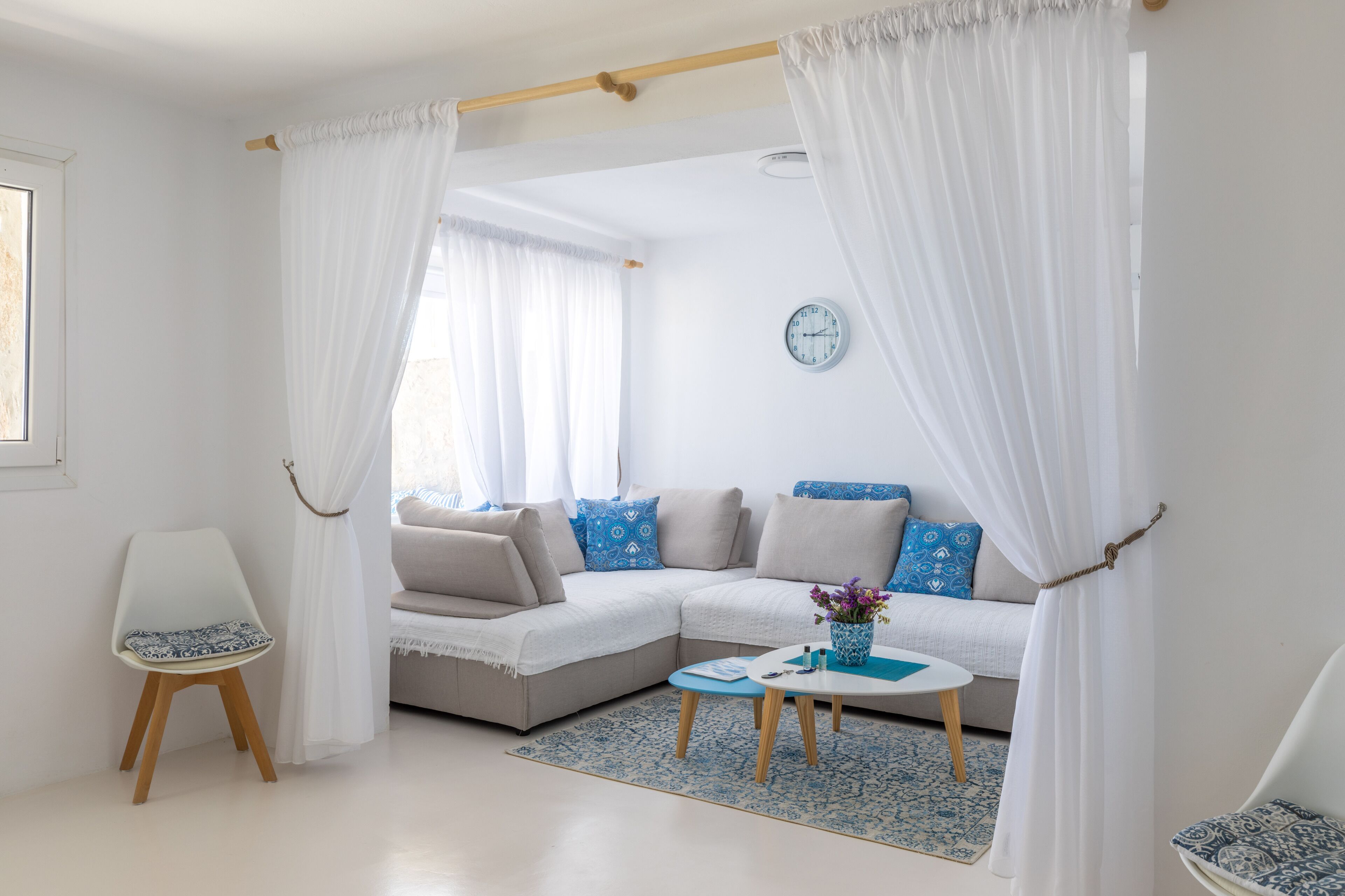 A modern living room with a sectional sofa, a small coffee table, and a chair.