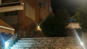 A set of stone steps leading up to a building with a balcony. - Kanakaris Apartments (Xylokastro-Evrostina)