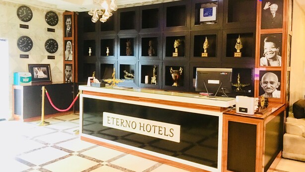 A reception desk with a sign reading "ETERNO HOTELS". - Eterno Hotels Limited (Benin City)