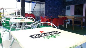 An outdoor seating area with tables and chairs, some branded with Heineken. - Euro Lounge and Suites (Ibadan)