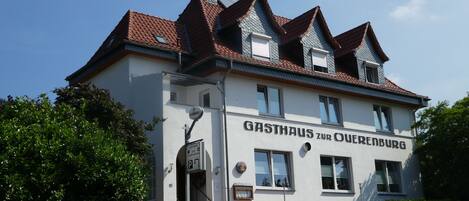Un edificio con un letrero que dice 'GASTHAUS ZUR OBERENBURG'.