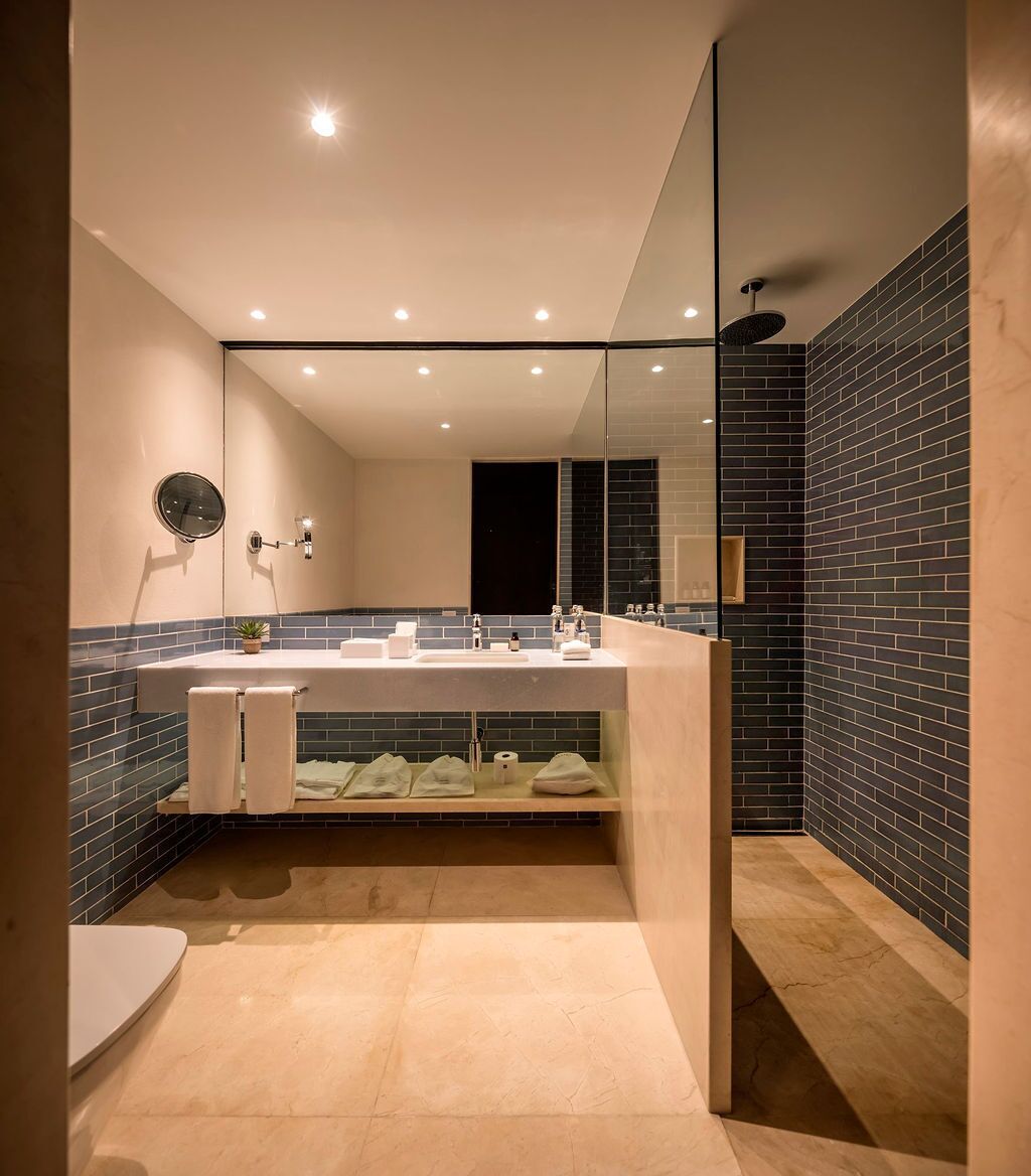 deluxe room | bathroom | separate bathtub and shower, rainfall showerhead, hair dryer, slippers