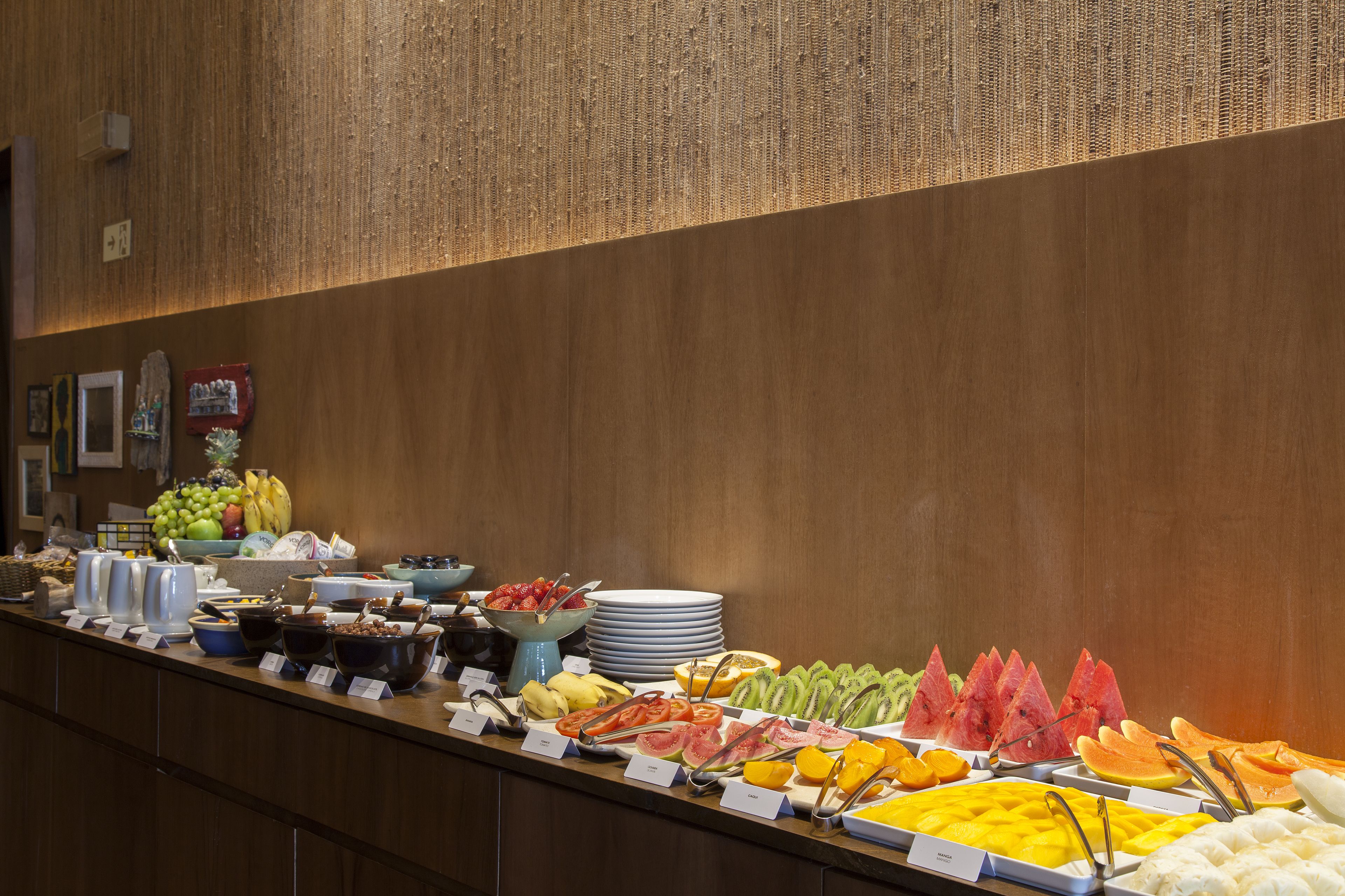 A buffet with various fruits and vegetables, including watermelon, kiwi, and oranges.