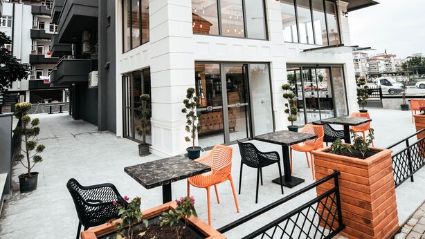 A hotel with a modern design, featuring outdoor seating and a visible entrance. - Hotel Derin Ma Sorgun (Manavgat)