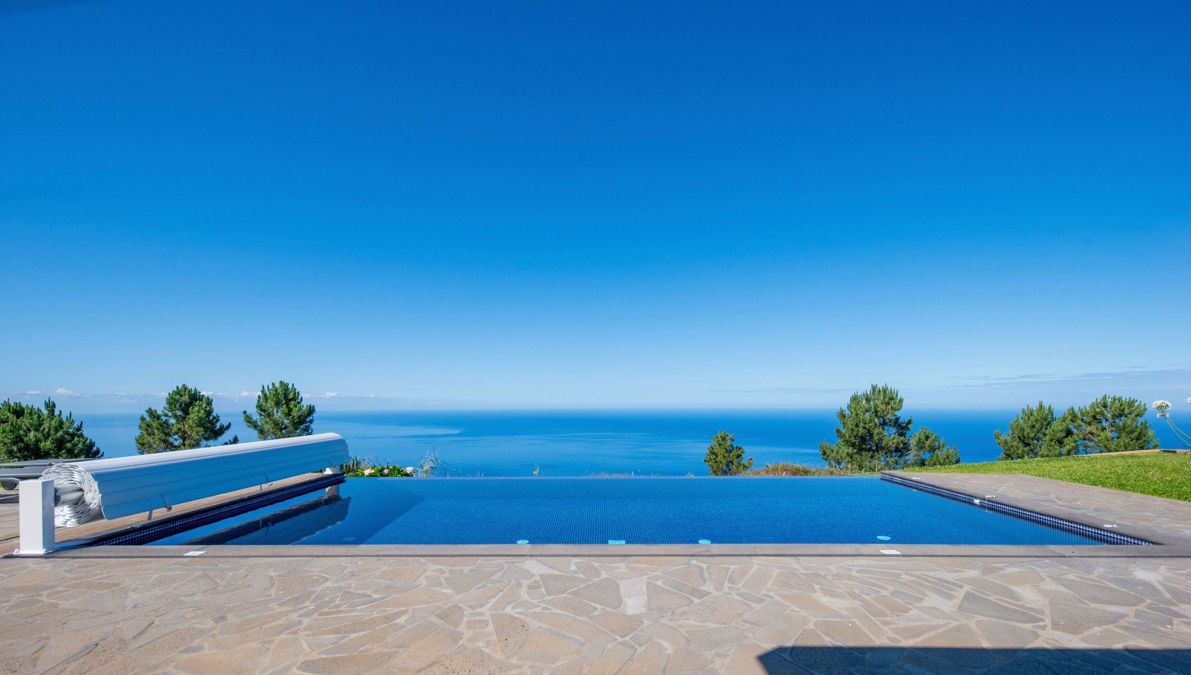 Outdoor pool, a heated pool, pool umbrellas, pool loungers