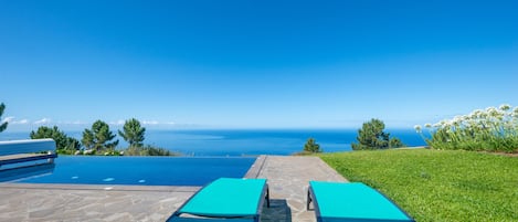 Outdoor pool, a heated pool, pool umbrellas, pool loungers