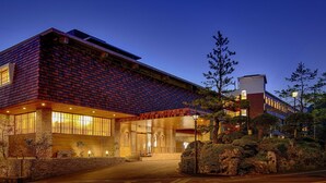 A modern building with a brick facade, large windows, and a stone entrance. - Ooedo Onsen Monogatari Unzen Toyokan (Unzen)