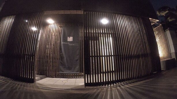 A modern building with a metal facade and a sign that reads "TERRACE HOUSE".
