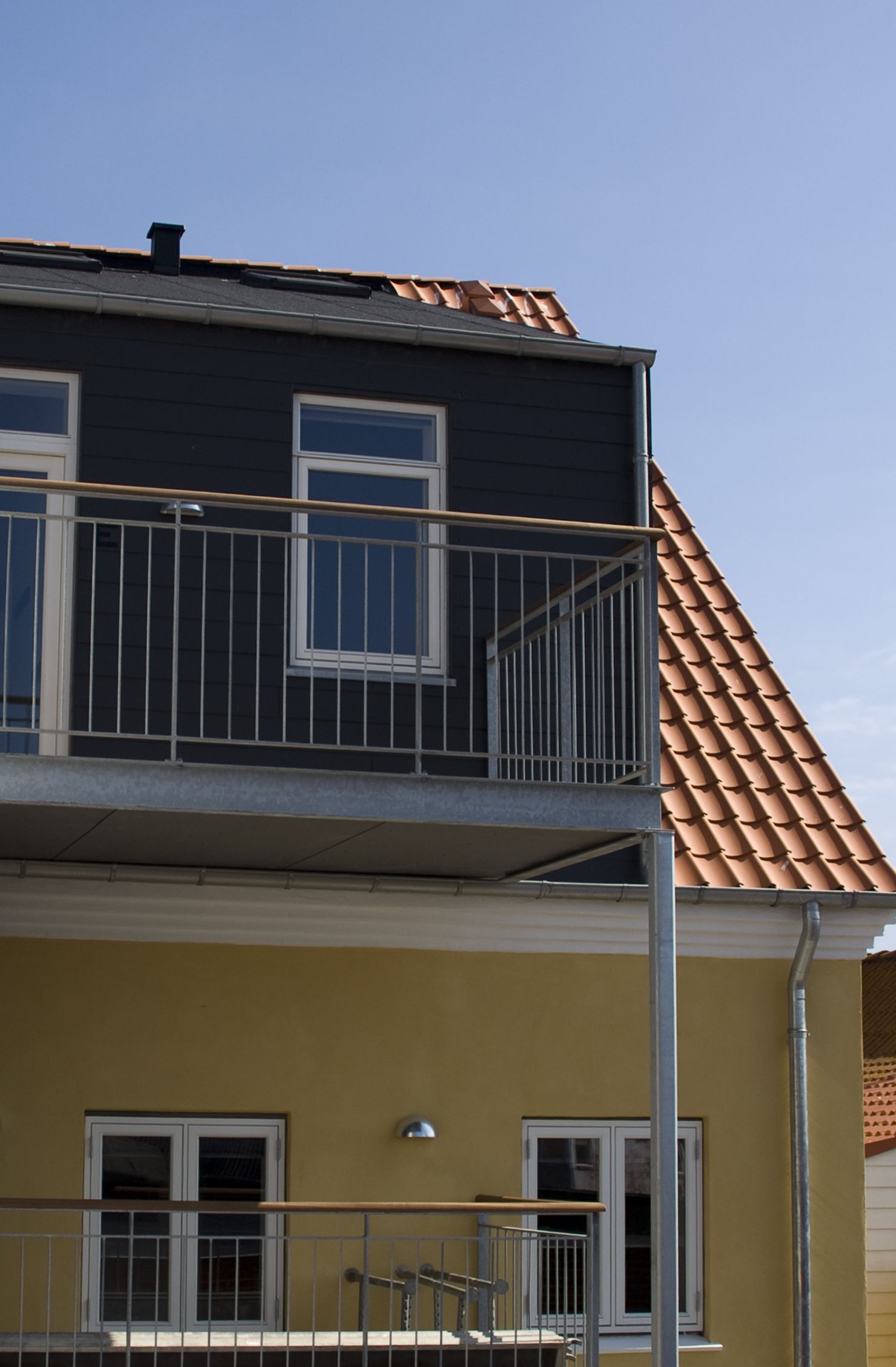 A two-story building with a balcony on the upper floor.