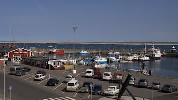 A marina with boats docked, a parking lot with cars, and a building labeled 'FISKEHALLEN'.