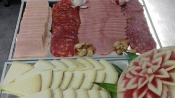 A display of various food items including sliced meats, cheeses, and fruits.
