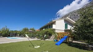 A residential area with a swimming pool, a slide, and a tennis court. - Villa Pocelje a beautiful view of nature and sea.  (Omiš)